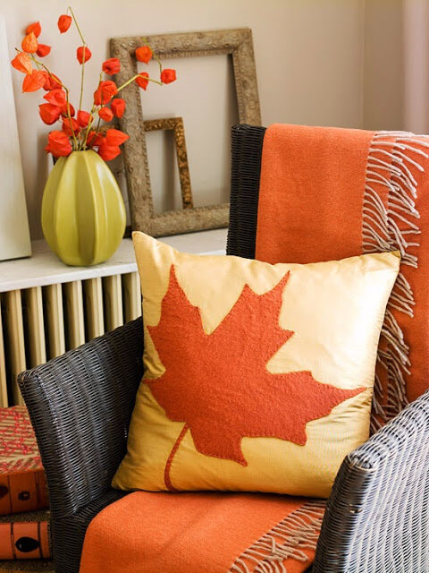 Wicker chair with fall leaf pillow for the fall season