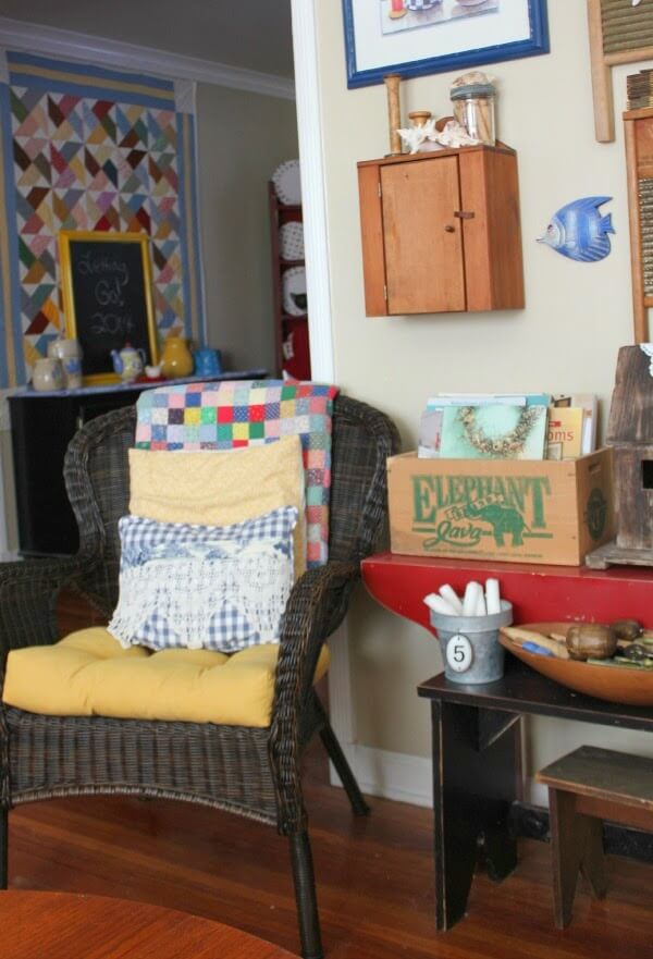 A quilt on the wall and one folded over a wicker chair shows the joy of quilting