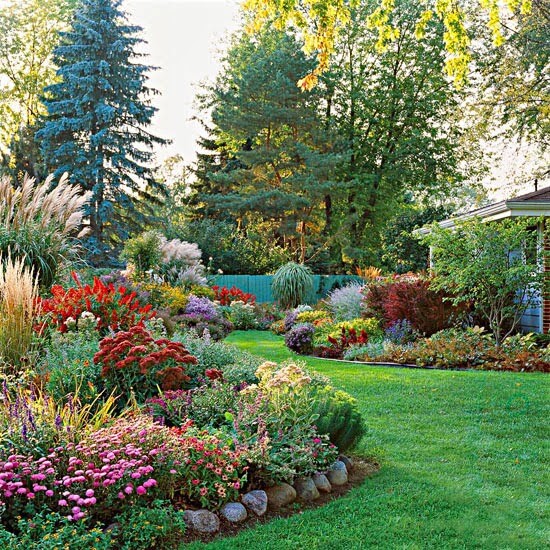 A yard with landscaped gardens surrounded by stones