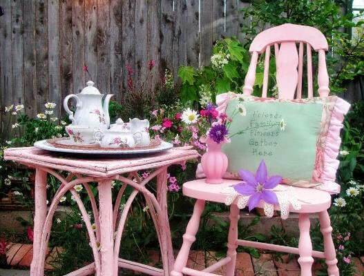 In Becky's Gardens Of Whimsy, a pink vintage chair and table