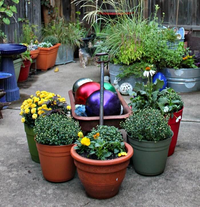 In Planting For Fall & Spring, this is my vintage wagon with gazing balls surrounded by pots of fall plants