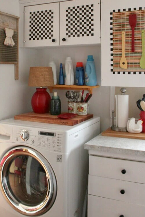 Over the washing machine, I used some of the contact paper in the middle to match the faux frame around the placemats I tacked on the doors.