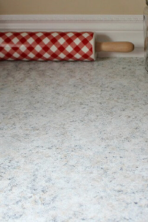 In apartment kitchen #3, I took down the adhesive tiles and painted the backsplash and applied a GianiGranite kit to the countertop.