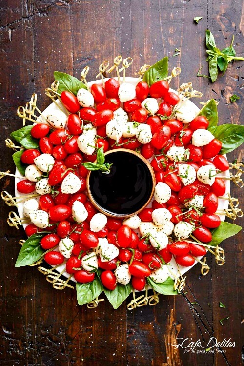In 10 Christmas-Themed Appetizers, the first one is a caprese Christmas wreath by Cafe Delites.