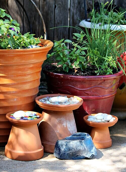 I put terra cotta pots and saucers on my patio with stones inside.