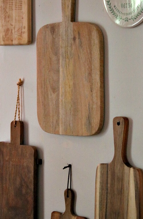 Cutting boards hanging on kitchen wall