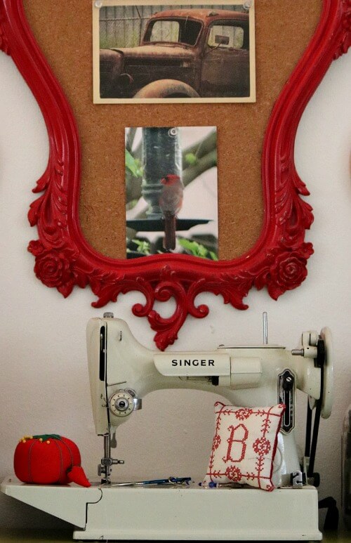 In My Office/Craft Space In My Living Room, this is my red framed bulletin board with photos and postcard of old truck