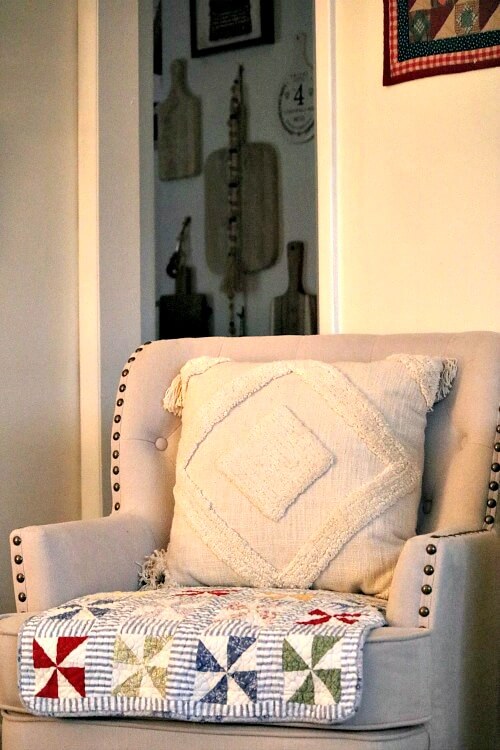 Change Up The Look Of Furniture Without Spending Money by putting a small quilt in the seat of the chair