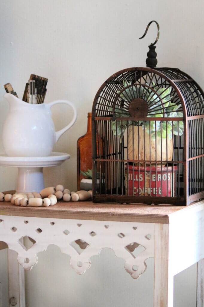 A brown birdcage I bought at the consignment store.
