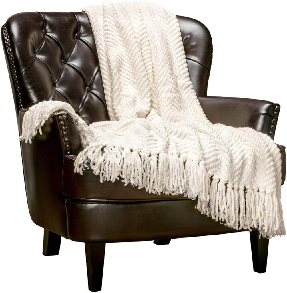 Ramp up the cozy for fall with this cream-colored throw blanket with tassels