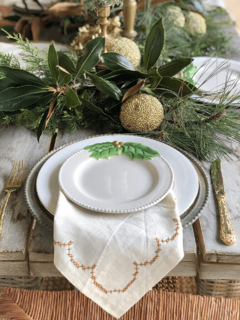 A Christmas tablescape with fresh greenery