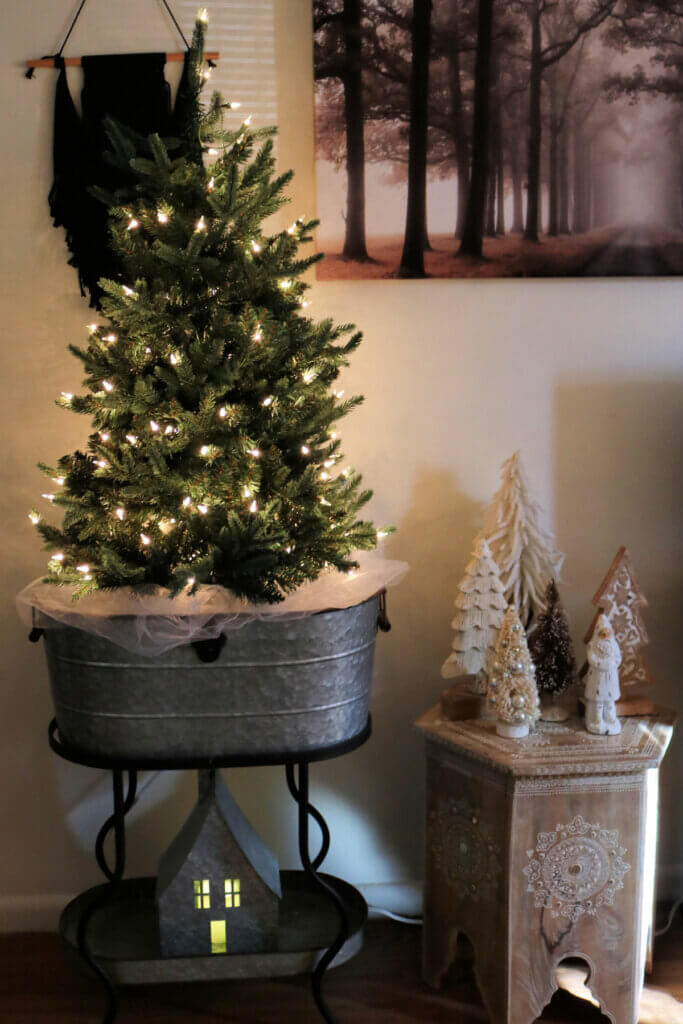 For my Christmas decor 2021, I have a tabletop tree with just the lights and a boho table with Santa and small trees.