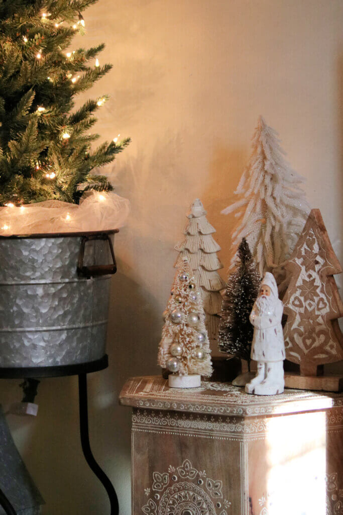 My Christmas Decor 2021 is scaled down to a beverage tub with a tabletop tree inside with just the lights for decoration. As well as my boho table with trees and a santa.