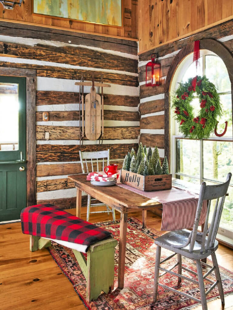 Rustic walls in this Tennessee log cabin are the perfect background for their rustic dining table