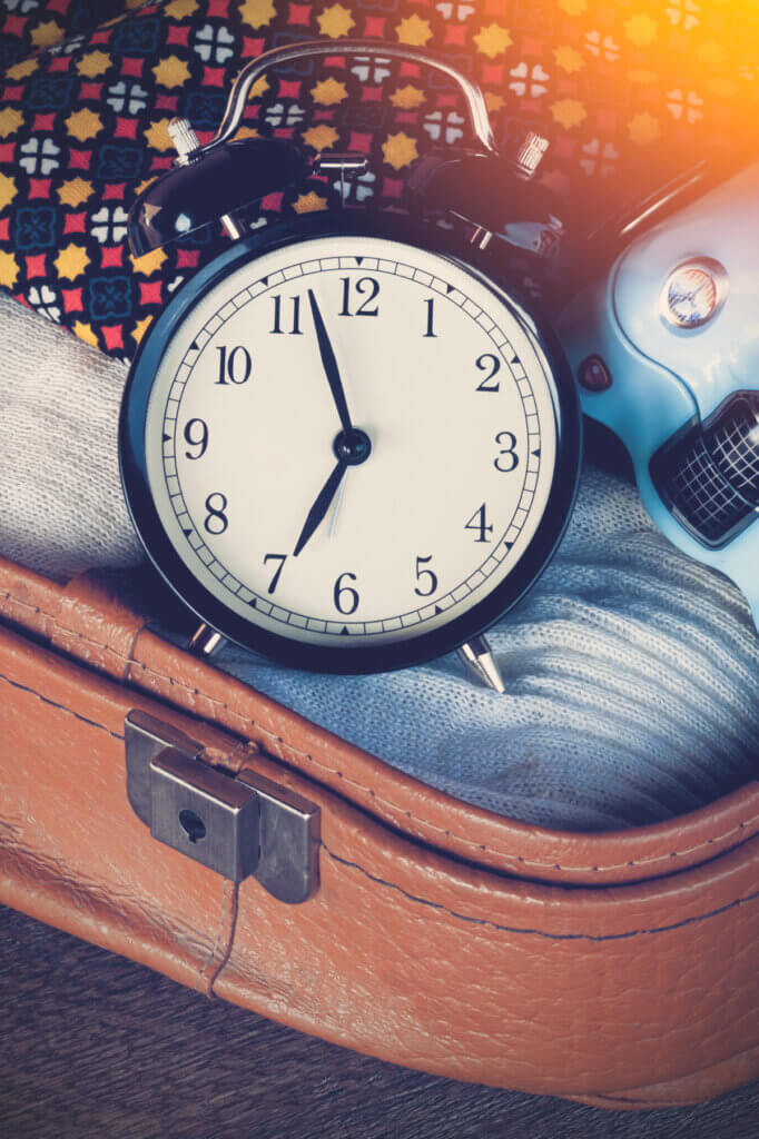 In Sunday: 3 days till moving day, here is a clock setting on an open packed suitcase