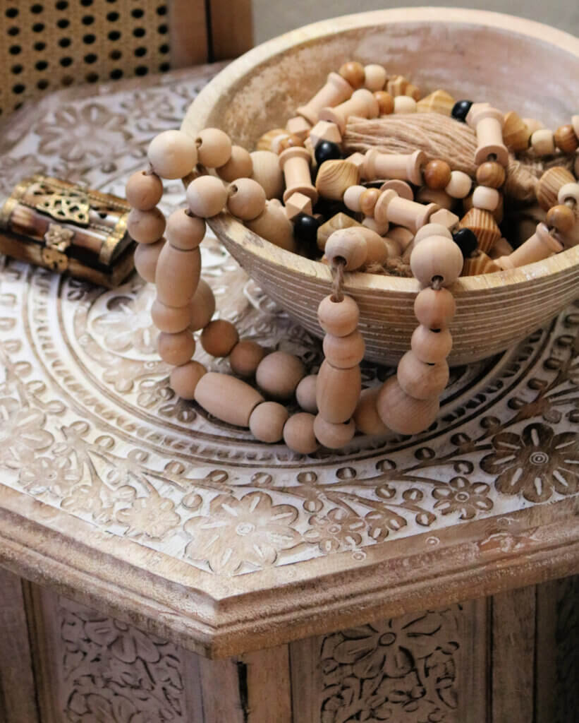 In Life Is A Kaleidoscope, there is a wooden bowl filled with a strand of wooden beads