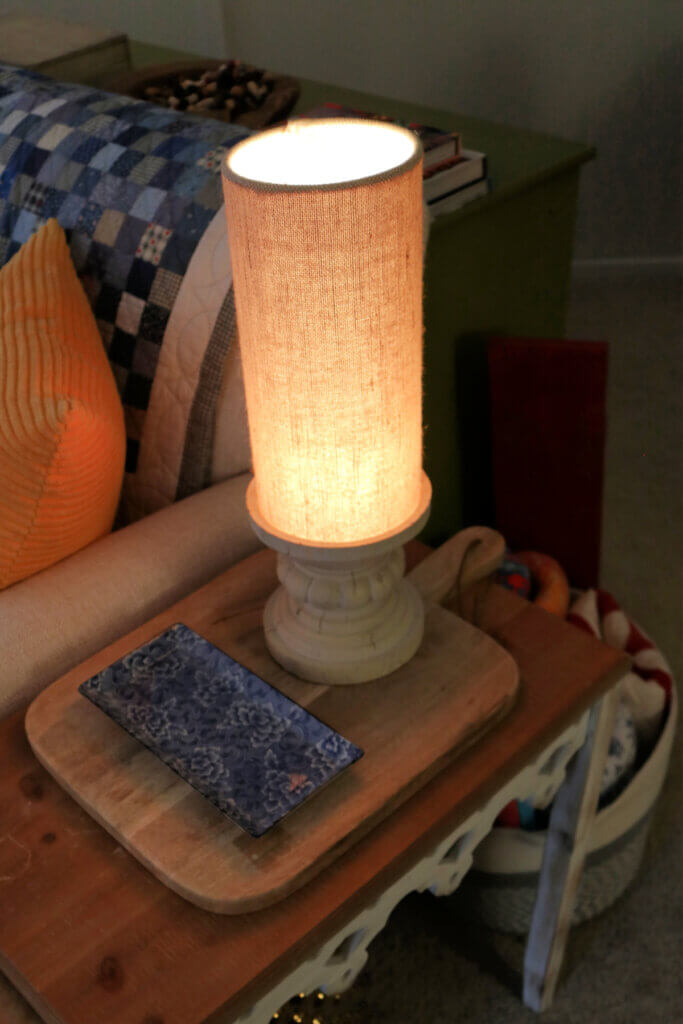 A lamp on an end table next to my couch