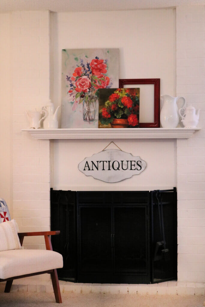 In this post, the fireplace and mantel, this is how I leaned the paintings on the mantel.