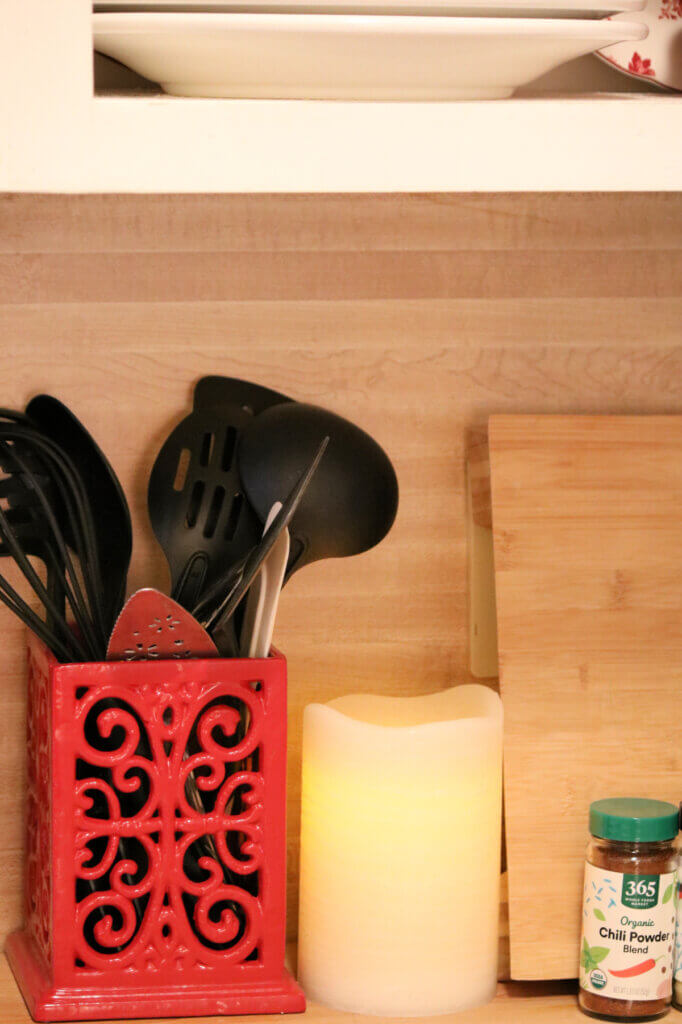 In 10 Tips For A Cozier Kitchen, put your kitchen utensils in a pretty container.