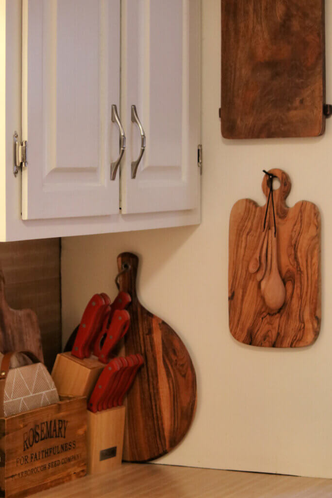 Hang up your wood cutting boards or arrange them in the background