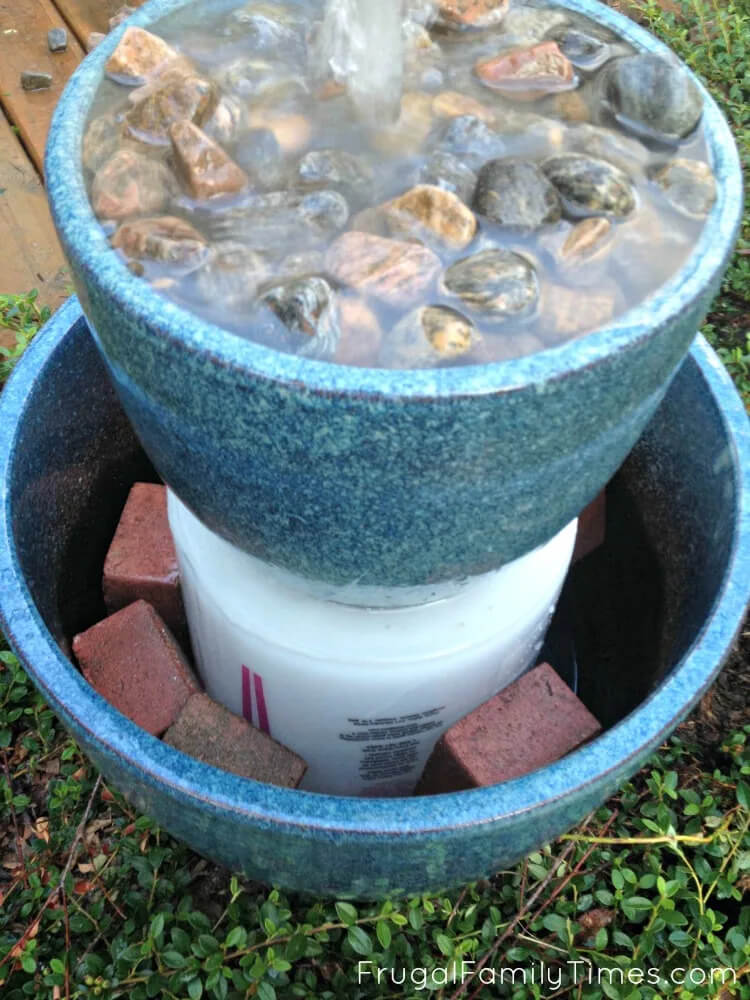 This blogger used 2 blue ceramic pots to create her DIY water fountain