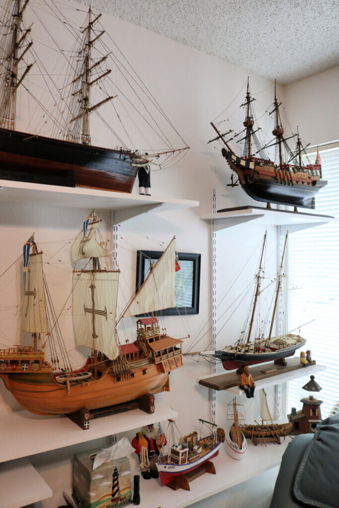 In More Of Neighbor Ron's Ship Yard & A Diorama, this is a wall of his extra bedroom with all sizes and shapes of ships he has built.