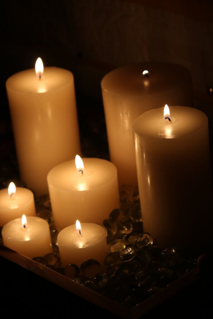 In Good Men Do Good Things, these gathered candles gleam in the darkness
