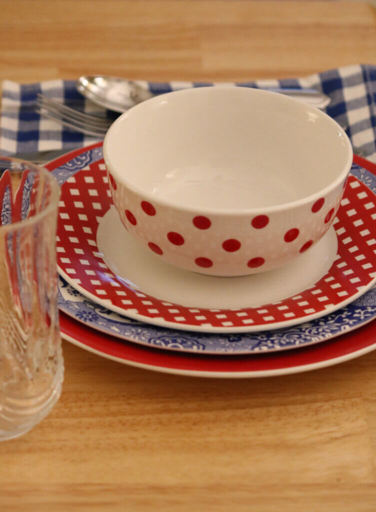 In my table setting, I already had the glasses and silverware. But the red, white and blue dishes make everything pop.