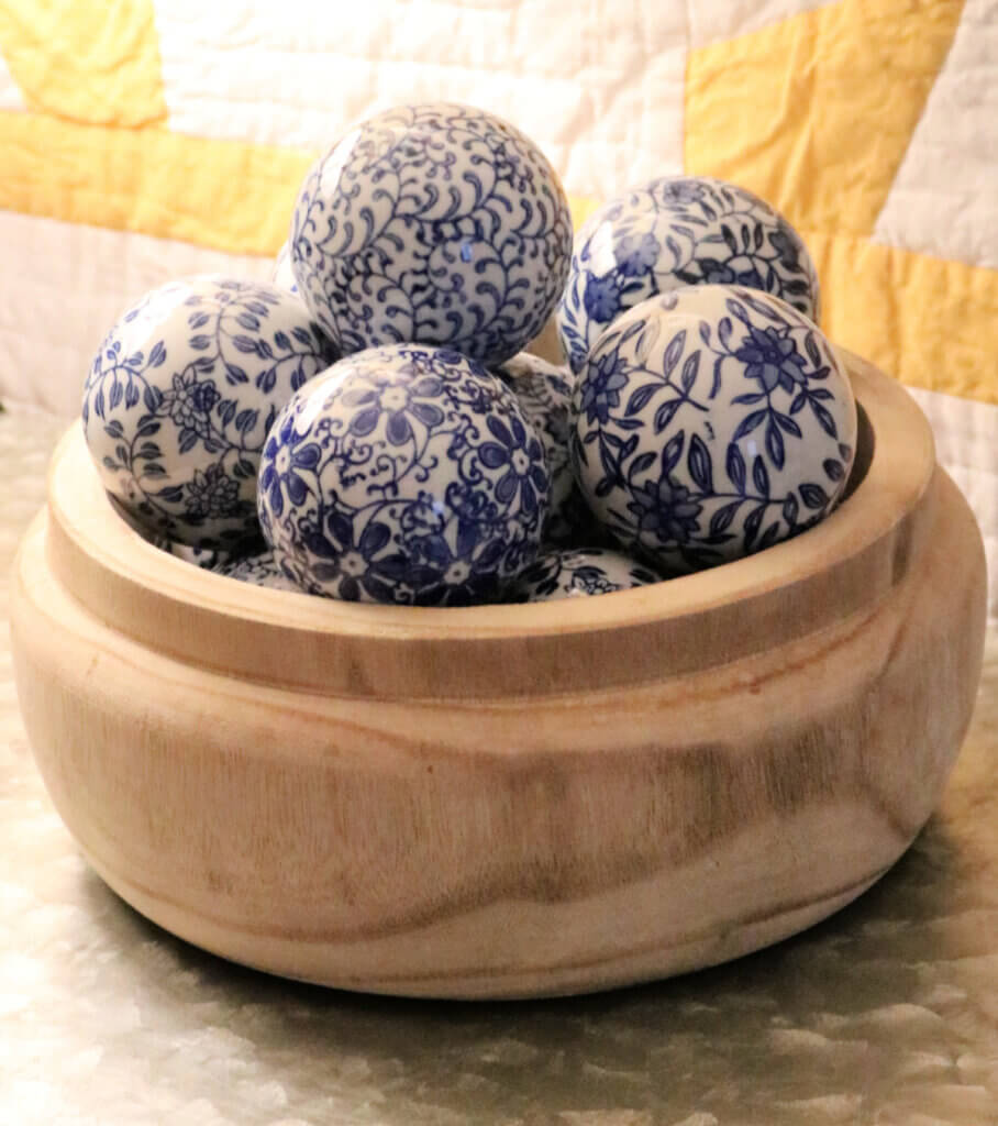 A wooden bowl and blue and white ceramic bowls, all purchased from Tuesday Morning.