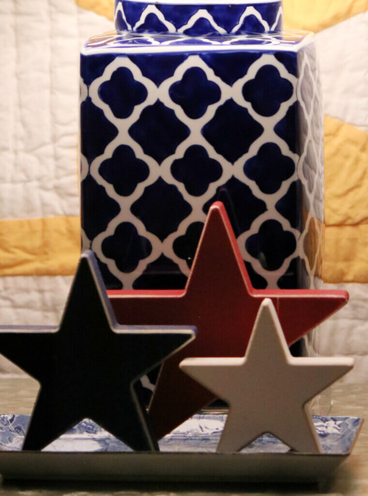 My navy and white lamp with patriotic colored wooden stars in front of it.