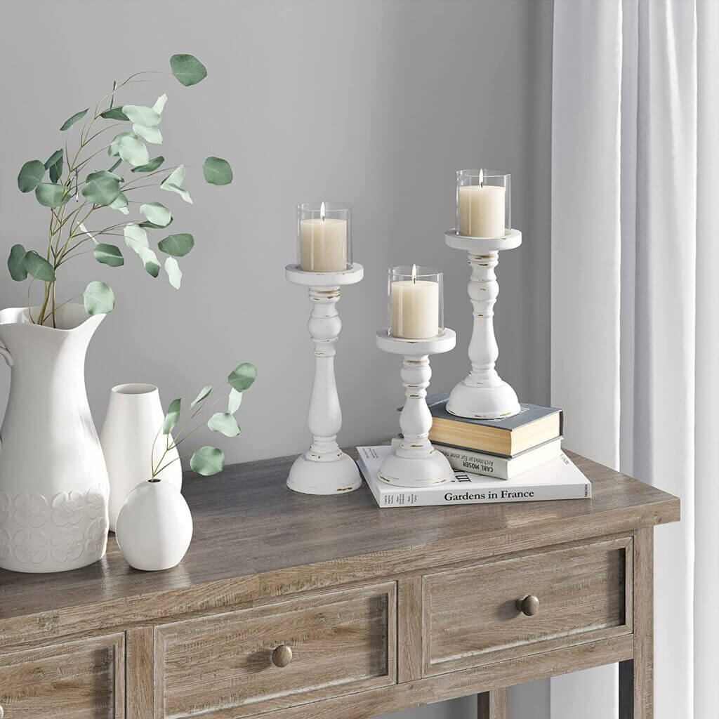 At Red & White Finds At Amazon, this set of distressed white pillar candle holders 