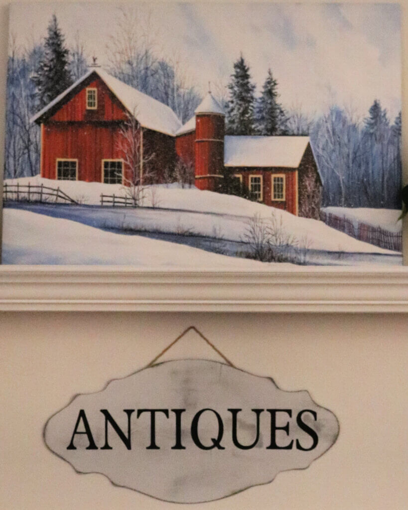 In Snow Painting In The Living Room, there is my antiques sign hanging below it.
