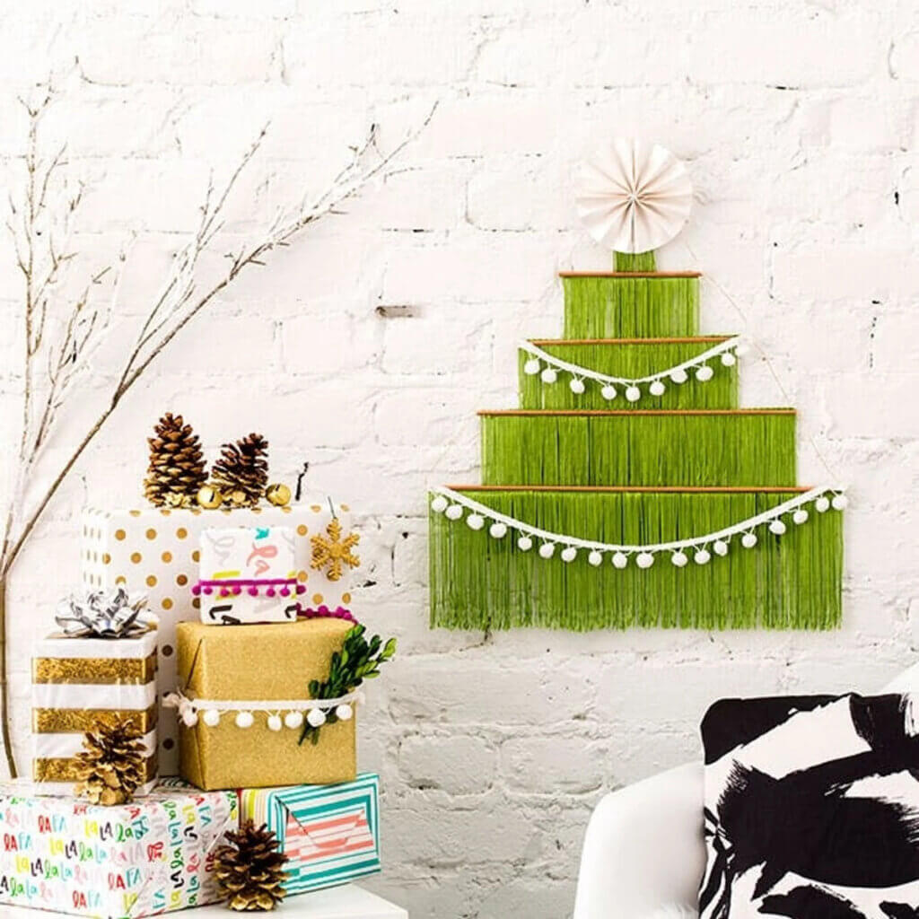 A boho crafted alternative Christmas tree on the wall.