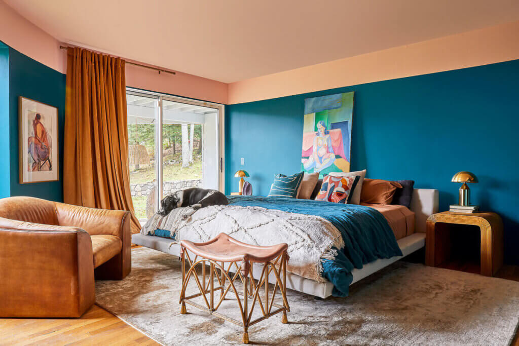 In A Collector's Colorful New York Home, the bedroom has turquoise walls
