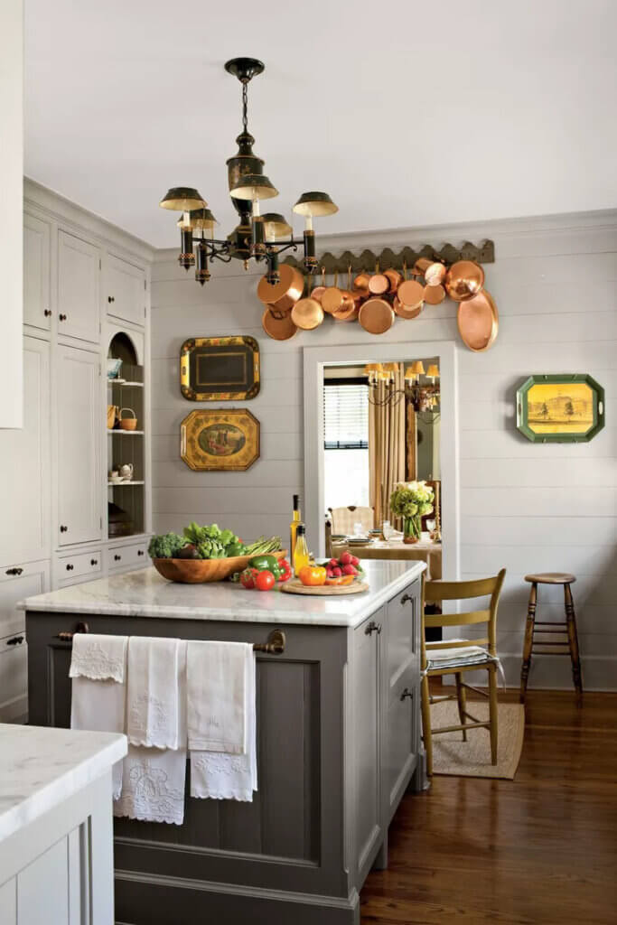In what is a modern farmhouse kitchen, you will often see less white and more varied colors for cabinetry