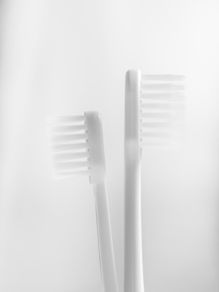 Two toothbrushes pointed in opposite directions.