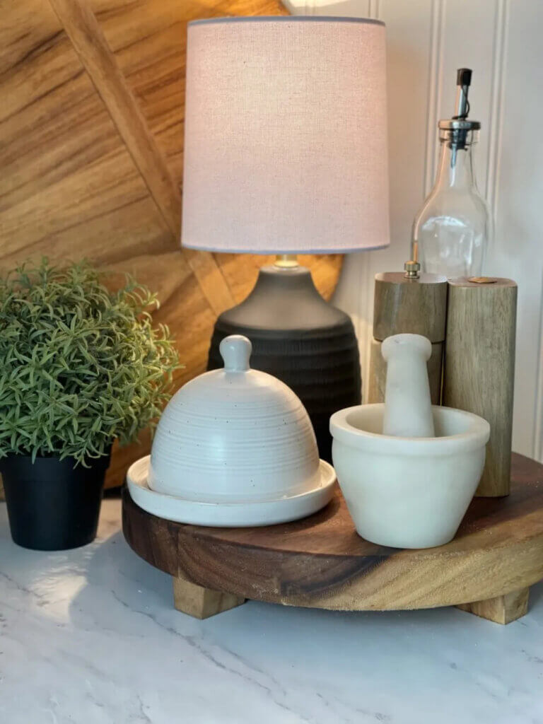 In Small Lamps In Kitchens, this blogger corralled her kitchen items on a decorative wood riser