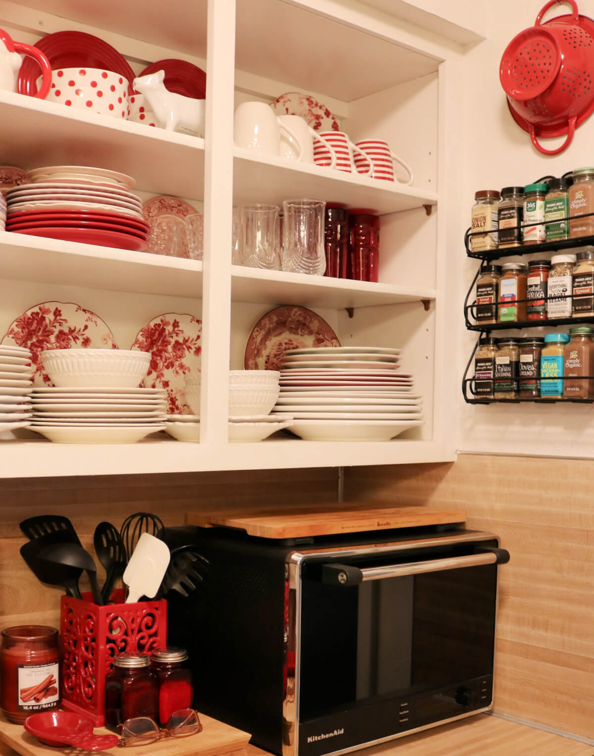 My open kitchen cabinets with red and white dishes in it.