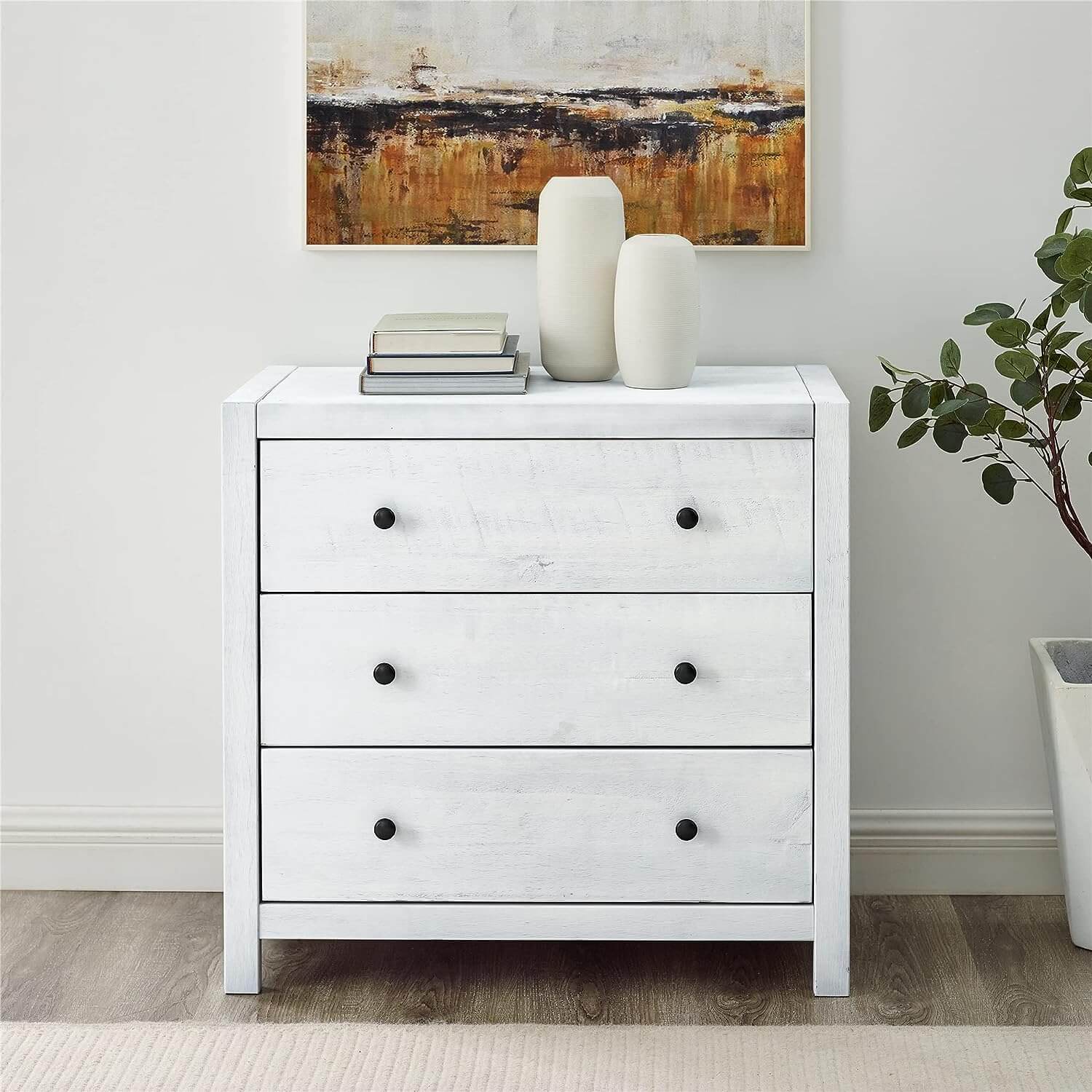 In The Quest For A Dresser, a white farmhouse style with black knobs