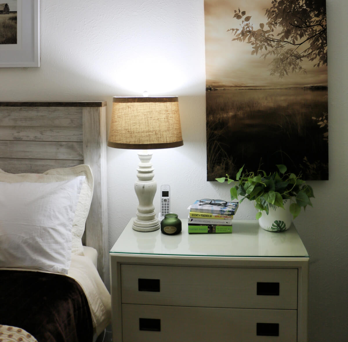 My dresser on this side has a lamp, candle, stack of books, and a house plant.