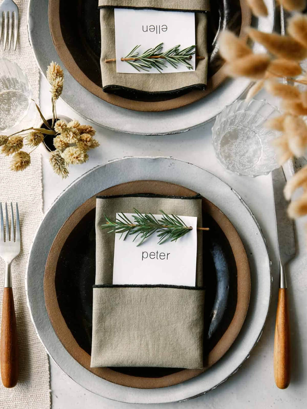 In 10 Thanksgiving Place Card Ideas, a sprig of rosemary is in a name card.