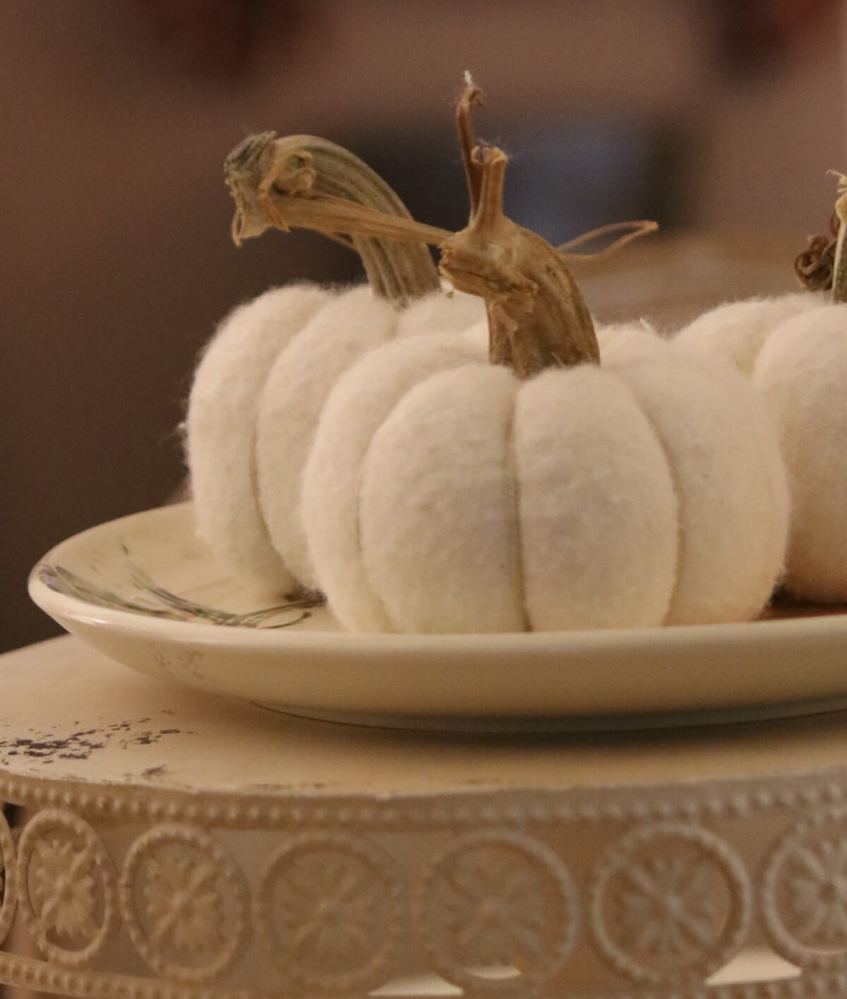 In Cozy Minimalist Fall Decorating, a trio of felt pumpkins on the table