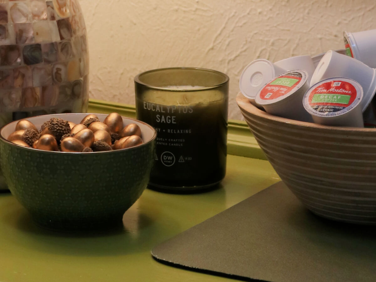 In Cozy Minimalist Fall Decorating, the coffee bar with a green bowl of gold acorns