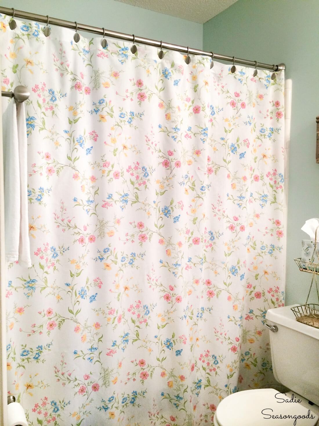 In Repurposing & Decorating With Vintage Linens, this is a vintage sheet turned into a shower curtain