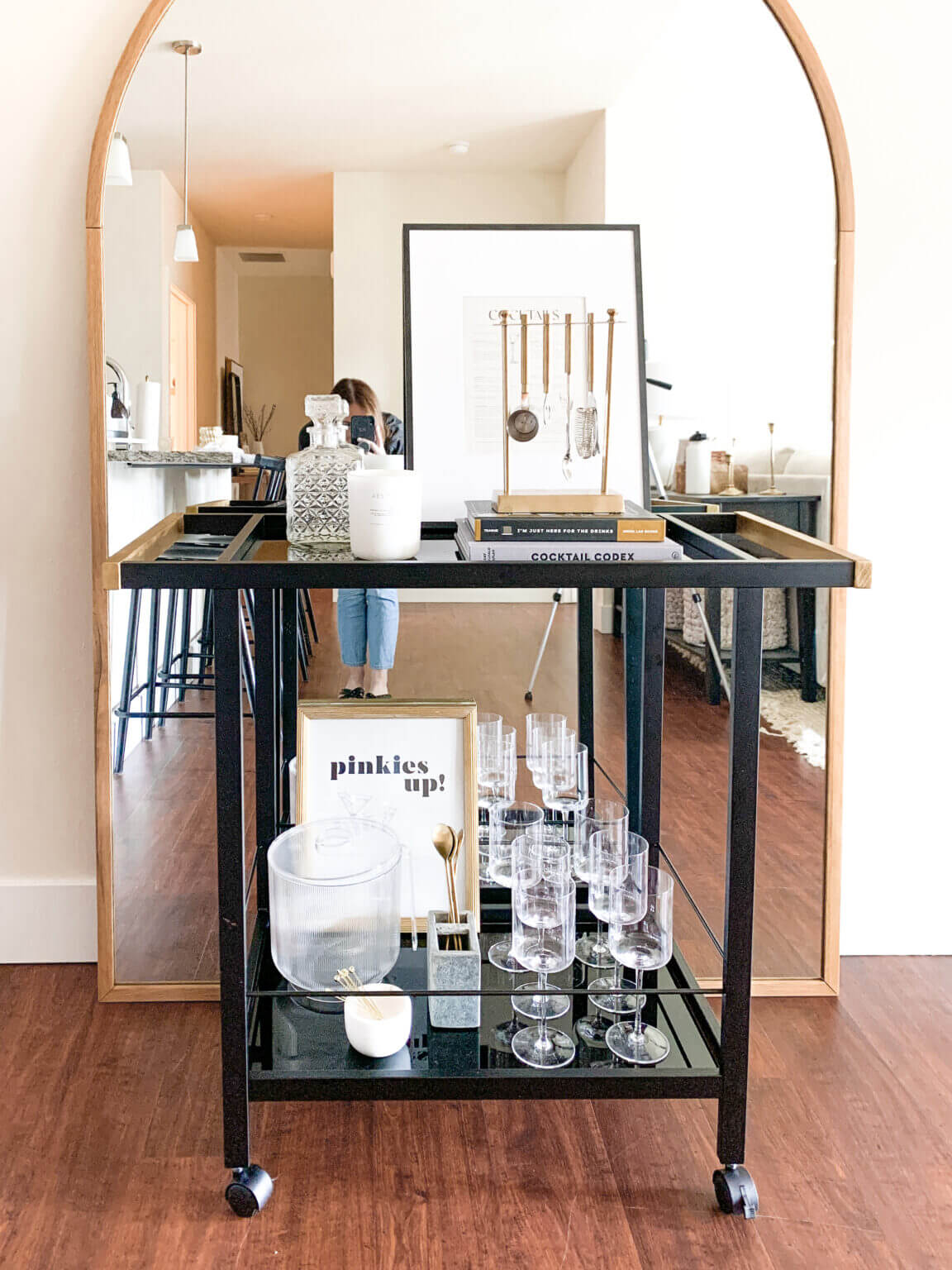 In Ideas For Small Living Room Furniture Placement, this is a bar cart set up with drinks in front of a floor mirror
