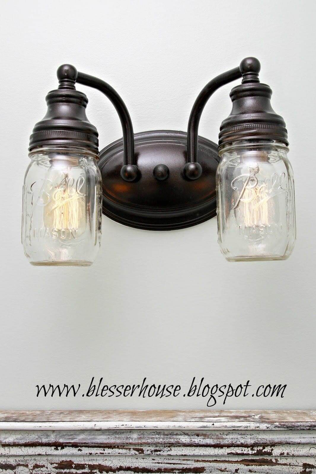 In Creating A Vintage Mason Jar Ceiling Light, this is a mason jar light created by the bloggers at Blesser House
