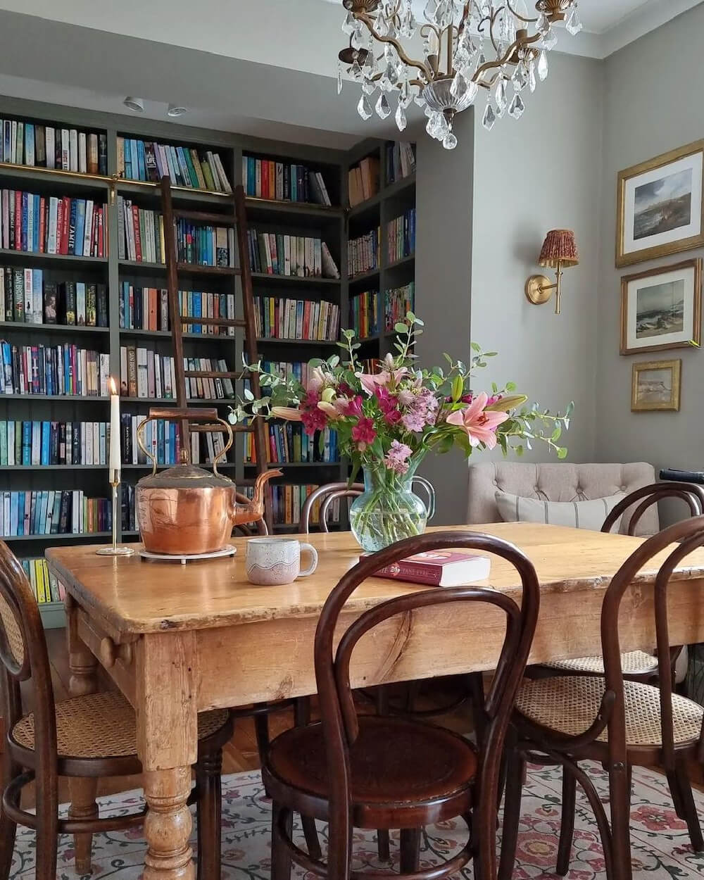In The Love Of Home Files #2, this is a cozy home library with a table and chair.