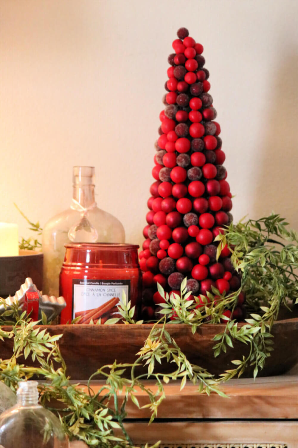 In my small space holiday trees, this is my little red tree with a candle and cookie cutter in a dough bowl.