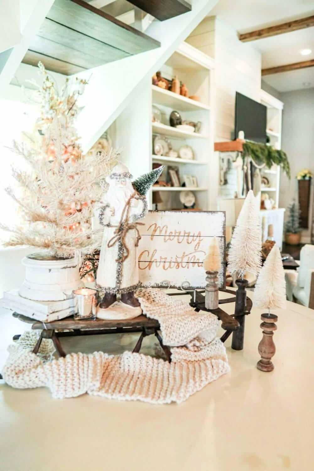 In 10 Christmas Vignettes On Display, a neutral Christmas vignette arranged on a vintage sled.
