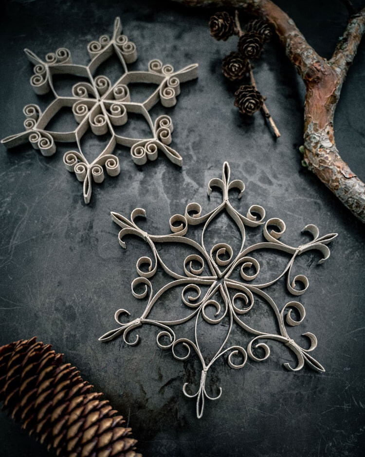 In Cozy Minimalist & Scandi Christmas Decor, handmade ornaments made from cardboard